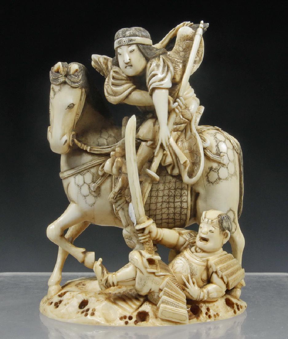 19TH C JAPANESE CARVED OKIMONO FIGURE OF FEMALE WARRIOR: Meiji period figure of an Onna-bugeisha, or female Samurai on horseback, possibly meant to be Ishi-jo, defeating her foe with a naginata (missing front tip). Signed on inset cinnabar block on undersid