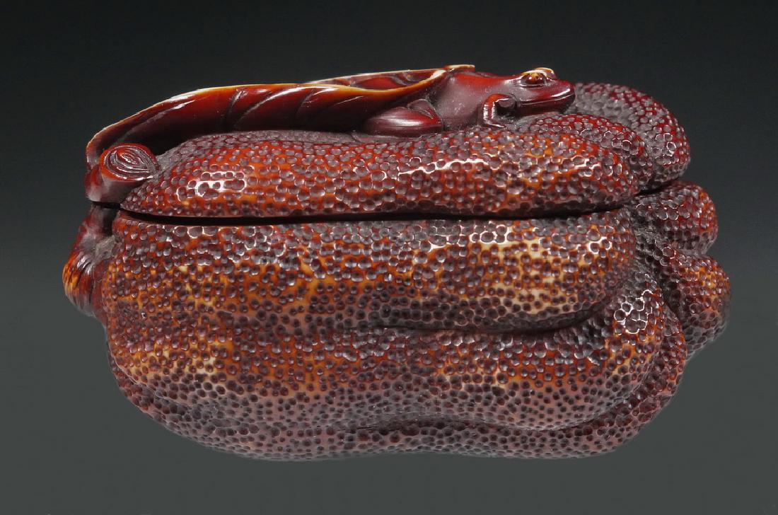 19TH C. JAPANESE CARVED GOURD WITH FROG: Meiji period carved and nut stained Buddha's Hand Citron Fruit with frog under leaf, 2 3/8" long. Nice wear to high points from use. Provenance: From the estate of Nancy Hamilton.