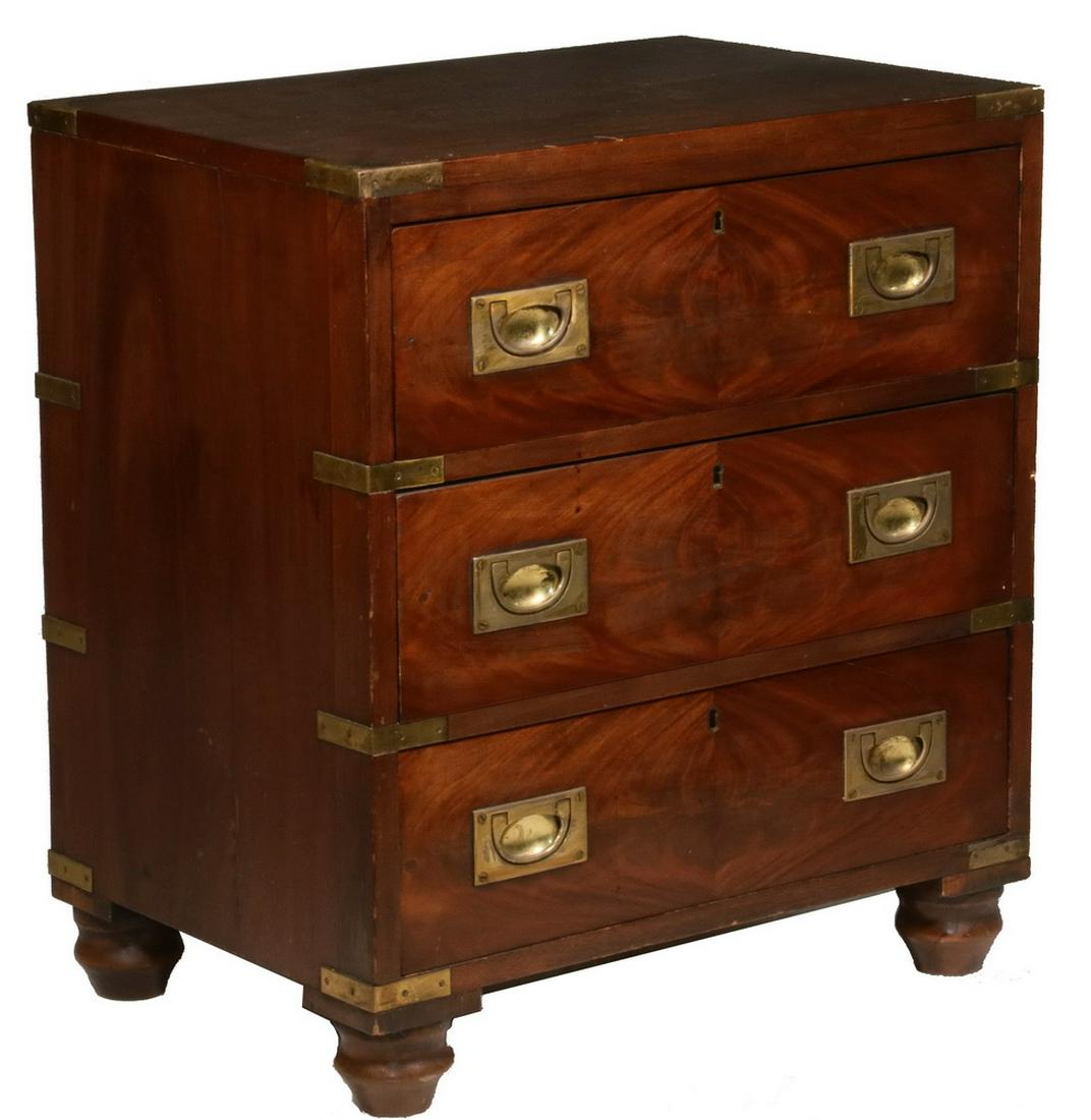 DIMINUTIVE CAMPAIGN CHEST: 19th c. Mahogany Three-Drawer Chest with brass corners, straps and flush mounted bail handles, quarter booked flame veneer to drawer fronts, pine secondary, on vase turned feet, 27" x 24 1/2" x 17 1/4