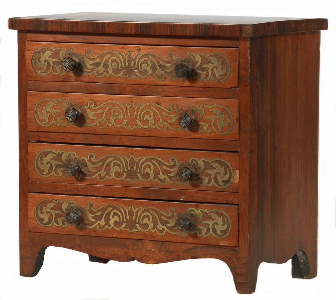 MINIATURE INLAID CHEST OF DRAWERS: Hepplewhite Four-Drawer Chest, possibly apprentice made, in rosewood veneer, with overhanging top and four graduated dovetailed drawers featuring inlaid brass scroll fretwork, ebony button pulls, cyma