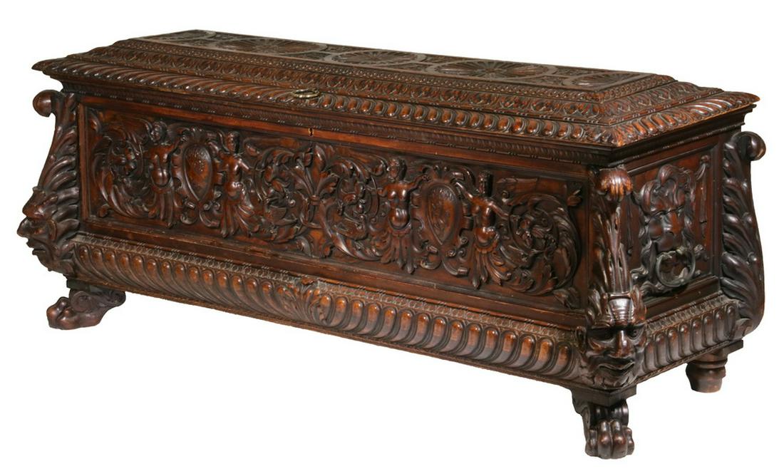 17TH C. ITALIAN CARVED CASSONE: Renaissance Style Casket in black walnut, having a solid top with sturdy brass ring lift, decorated with a set of four floral medallions on the top panel, edged by substantial bands of acanthus leaves