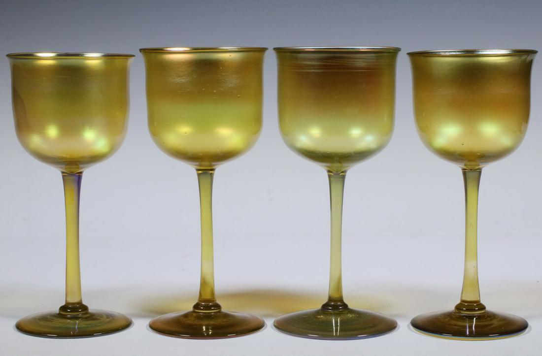 (4) TIFFANY STUDIOS FAVRILE WINE GLASSES: Set of (4) Early 20th c. Tiffany Studios Gold Favrile Iridescent Glass Wine Goblets, with slightly flared rims, each inscribed 'L.C.T.' on base, 5 3/4" high, 2 5/8" diam. Good condition.