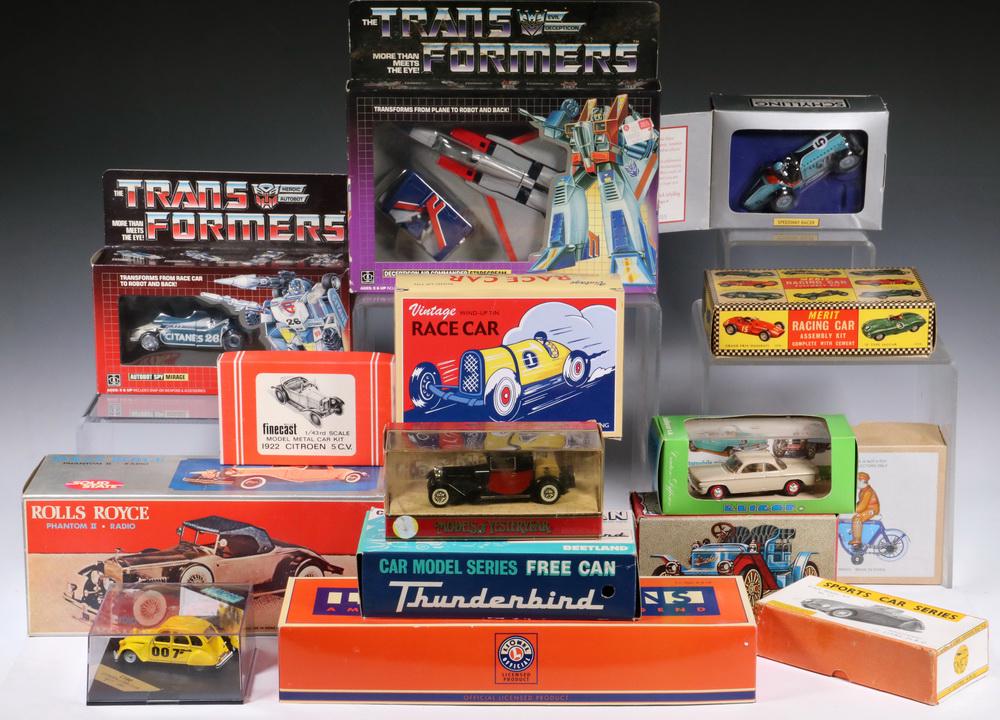 COLLECTION 1970S-80S AUTOMOBILE RELATED TOYS IN TWO: A wide range of plastic toys, most in the original packaging, almost exclusively cars, one specialty issue Lionel Legend in tin, a jet fighter, many 'Snoopy', Transformers, Rolls Royce radio, etc. Tra