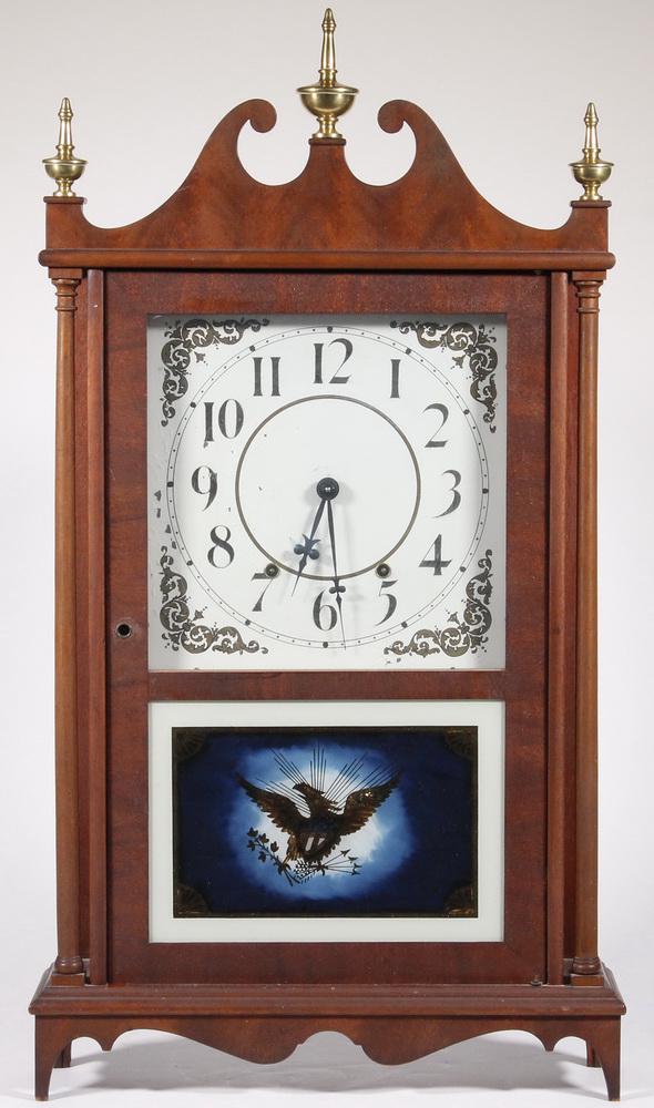 CONTEMPORARY SETH THOMAS PILLAR & SCROLL MANTEL CLOCK: Mahogany case, with brass finials, painted dial, lower glass having American Eagle gilt eglomise, includes key and pendulum. 30" x 17 1/2" x 5 1/2". Flaking to dial and eglomise.