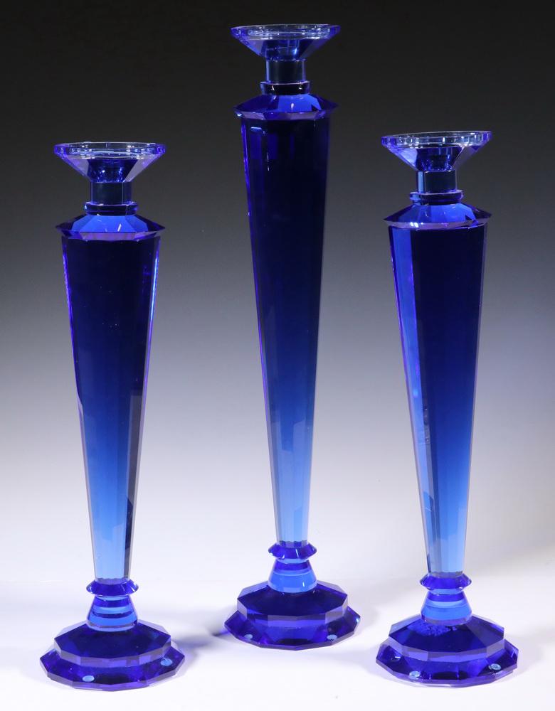 (3) BLUE CUT GLASS CANDLESTICKS: Set of (3) Large Contemporary Blue Cut Crystal Candlesticks, faceted sides, tapered stem, and round faceted base, pair: 20 1/2" high, and single: 24 1/4" high.