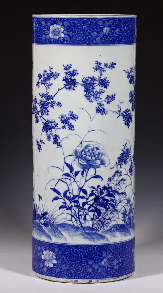 JAPANESE BLUE & WHITE PORCELAIN UMBRELLA STAND: Late 19th - Early 20th c. Japanese Blue & White Porcelain Cylindrical Umbrella/Cane Stand, with hand painted decoration depicting birds in a lush floral and tree landscape, top rim with Greek key deco
