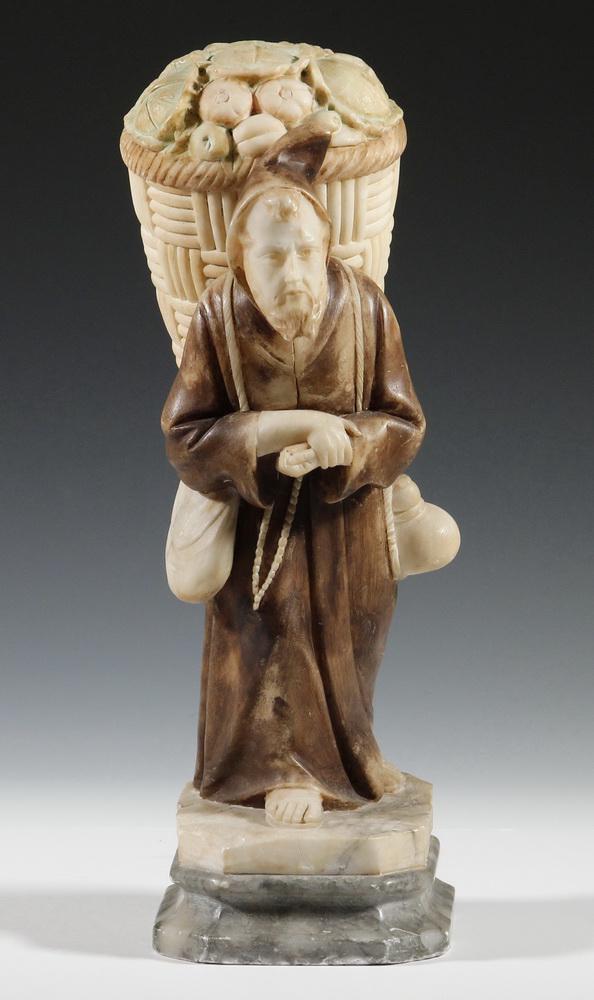 ALABASTER SCULPTURE WITH CONCEALED EROTICA: The Smuggling Monk, carved alabaster with hand coloring, circa 1900, depicting a monk carrying an enormous basket of produce on his back, with naked woman (!) concealed inside. She would have been rev