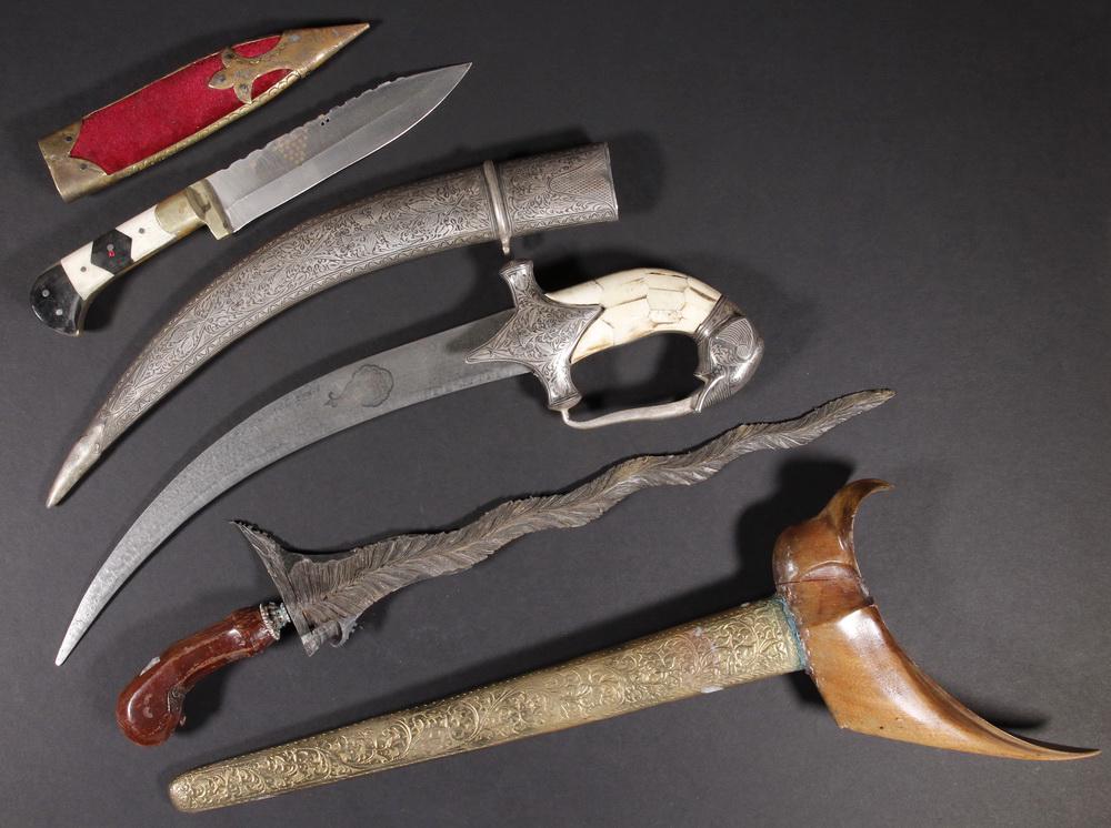 (3) ETHNIC DAGGERS: Malaysian Kris with bronze wavy leaf blade, deity carved handle, boat hilt in wood, 20" long; PLUS Indian Dagger with bone grip, niello sheath and elephant head form hilt, curved double-edged Damascus