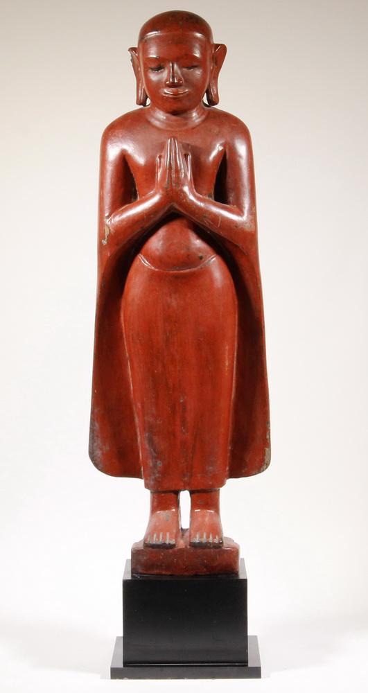 LARGE CARVED RED LACQUERED WOOD STANDING BUDDHIST MONK,: 19th c. of Enlightened Monk with hands in prayer, on a museum mount, 38" tall overall, 11" at widest point. Loss to back of base.