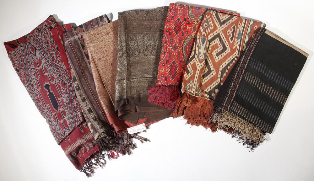 (7) INDONESIAN TEXTILES: Collection of (7) Indonesian Crafted Textiles, including: Ikat table cover in shades of red, blue and cream, with end fringe, 74" x 113" (9'-5") w/o fringe; Ikat tablecloth with figural pattern in sha
