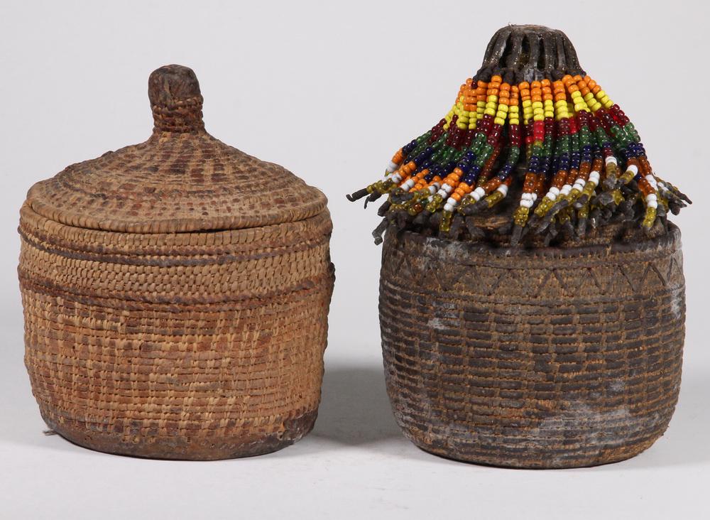 (2) BHUTANESE BASKETS: Lot of (2) Tightly Woven Bhutanese Round Lidded Baskets, early 20th c., one with bead decorations attached to lid finial, one with old hide repair sewn to base, 6 1/4 and 7" high, 5" diam. Surface wea