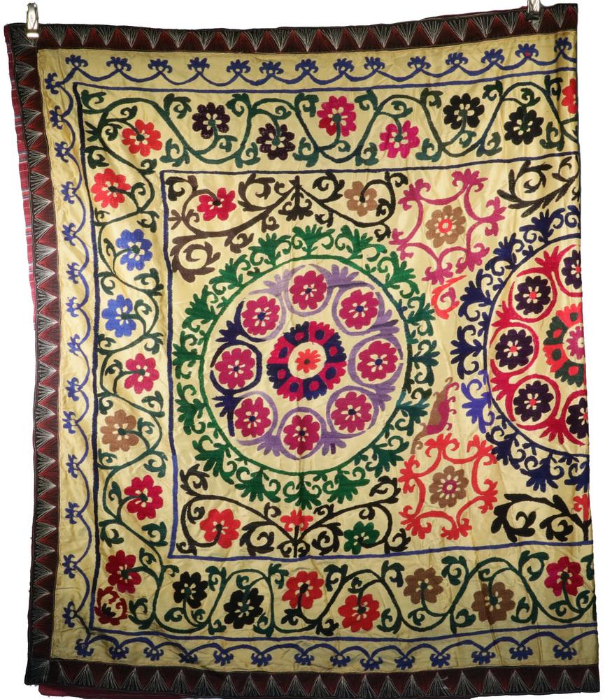SUZANI EMBROIDERED TABLE CLOTH: Vintage Afghan Suzani Embroidered Textile Table Cover, 20th c., with vibrant floral and swirl decoration, 56 1/2" x 94". Minor embroidery losses and discoloration, 'make do' patch to underside edge bi
