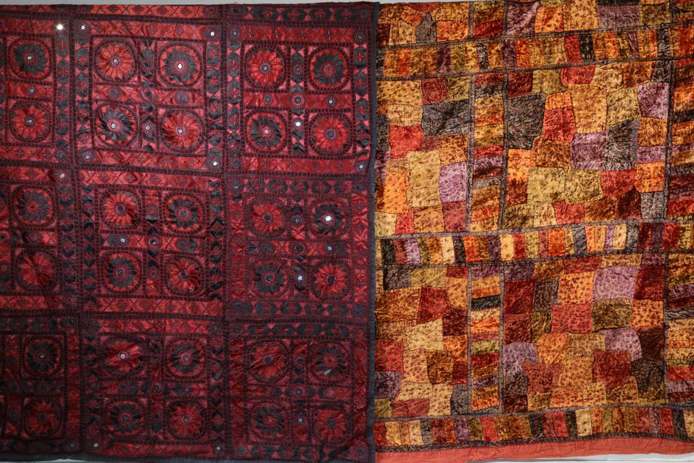 (2) INDIAN EMBROIDERED BED COVERS: Large Indian Embroidered Burgundy Bed Cover, with mirror work, black cotton backing, 86" (7'-2") x 102" (8'-6"), few embroidery pulls; and Pieced multicolored velvet in shades of terra cotta, orange, 