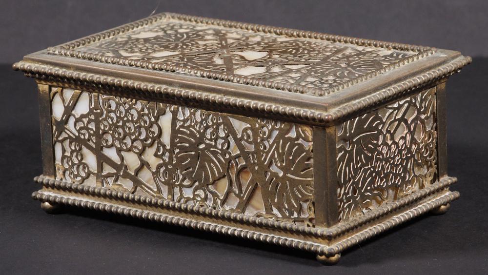 TIFFANY STUDIOS GRAPEVINE DESK BOX: Tiffany Bronze and Slag Glass Rectangular Desk Box, Grapevine pattern, #816, c. 1910, with hinged lid, pierced metalwork sides and lid lined with caramel and white slag glass panels, set on ball form 