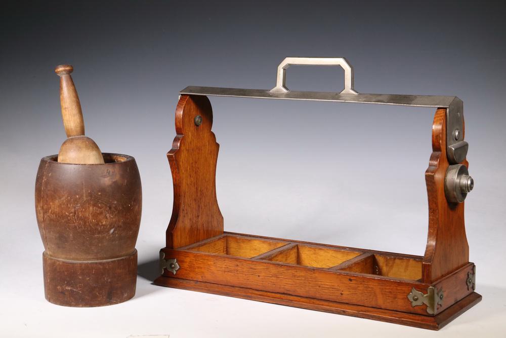 (2) WOODEN ACCESSORIES: Lot of (2) Wooden Items, including: 19th c. mortar & pestle, mortar: 7 1/4" high, 4 3/4" diam., pestle: 9 1/2" long, two cracks in mortar; and C. 1920s English oak whiskey bottle holder/tantalus frame