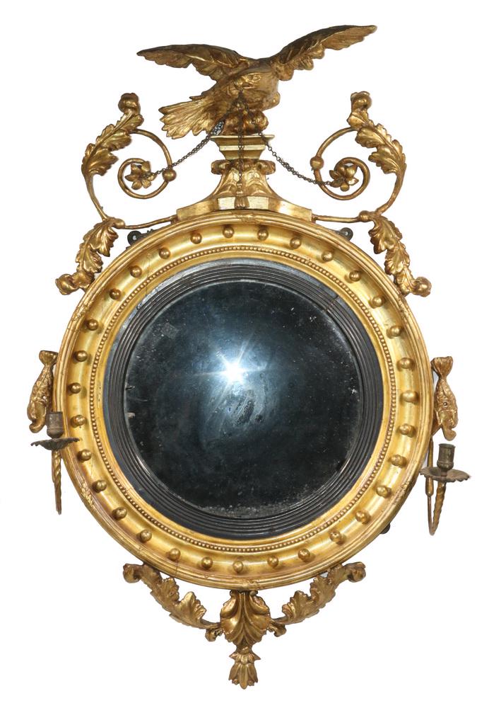 FEDERAL CONVEX GILDED LOOKING GLASS: Late 18th - Early 19th c. American Convex Gilded Looking Glass, topped with full body eagle in crest, flanked by scrolled and foliate sides, with original bull's-eye mirror glass, surrounded by a deep