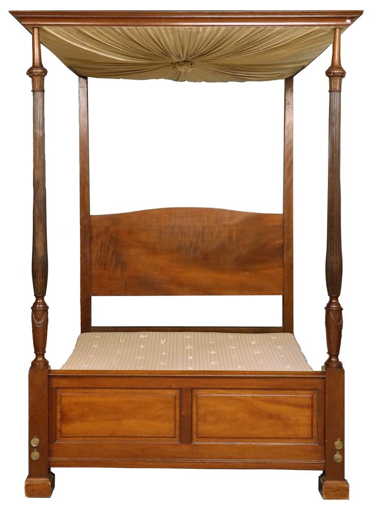 FEDERAL PERIOD MAHOGANY CANOPY BED: Circa 1810 Mahogany Bedframe with arched flame figured planked headboard, raised paneled footboard, tapered square head posts, the foot with molded square plinth stiles having gilt bronze bolt rosette