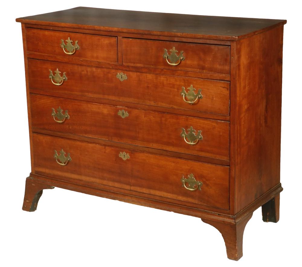 COUNTRY CHERRY CHEST: Two over Three Drawer Chest with overhanging top, the drawers with beaded edge and what appears to be the original brasses and escutcheons, simple molded bracket base set on extended feet, pine second