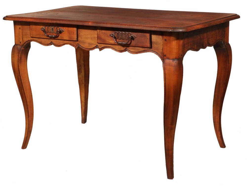 FRENCH BUREAU PLAT: Louis XV Fruitwood Bureau Plat, with large rectangular overhanging top with cleated ends and molded edge, fitted with two drawers with ornate pulls and escutcheons, with molded carved frieze and set o