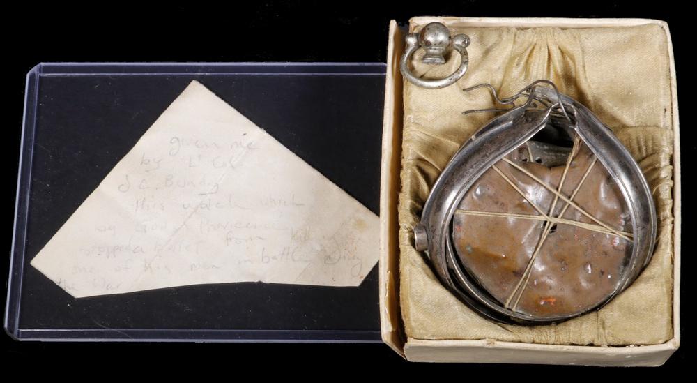 POCKET WATCH PIERCED BY BULLET GIVEN TO LT. COL. THOMAS: Shattered Pocket Watch now held together by wire and fine cord, pierced at the top and retaining the lead ball, with pencil note reading "Given me by Lt. Col. J.C. Bundy. This watch which by God's Pro