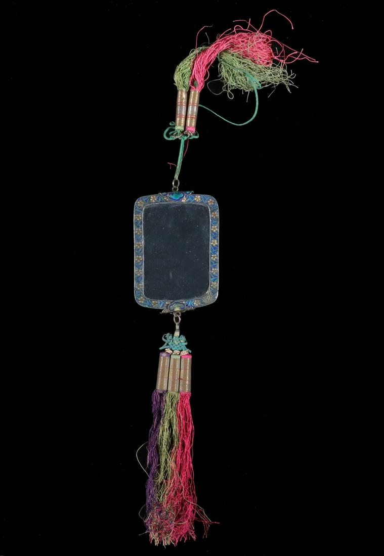 CHINESE HAND MIRROR WITH CARVED BACK PANEL: 19th c. Chinese Hand Mirror, with silk cord and tassels, cloisonne enamel floral decorated frame, carved panel depicting a woman with a qilin on a fretwork background, 3 3/4" x 2 1/2". Mirror glass re