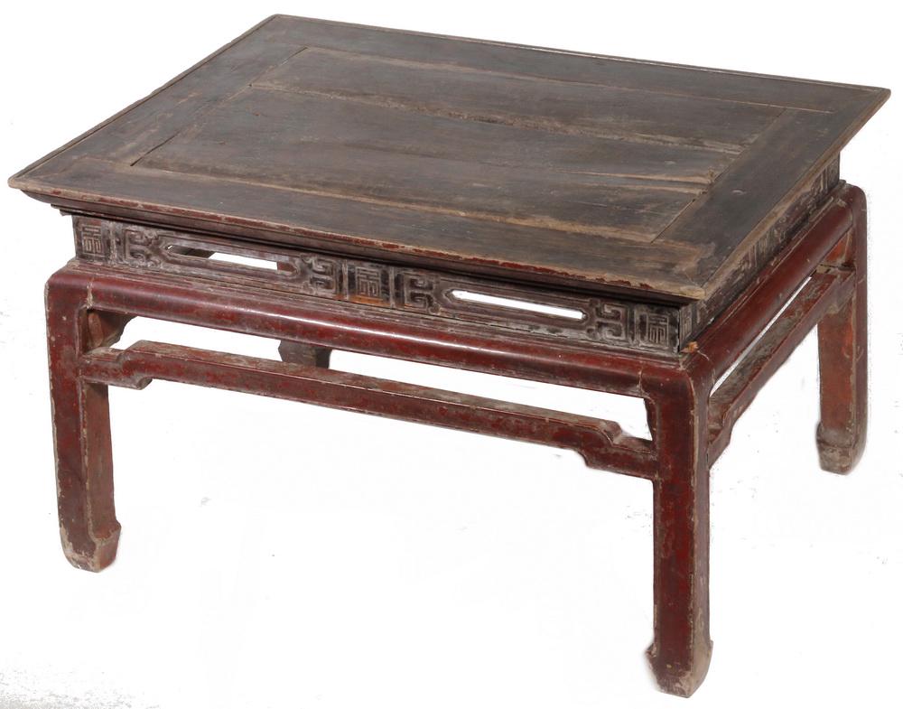 ANTIQUE CARVED AND PAINTED CHINESE END TABLE: 19th c. Ming style with black molded top, oxblood lacquered frame, having a molded and pierced frieze with archaic symbols, molded frame, shaped stretcher and knuckled feet, 16" x 27" x 21". Age and u