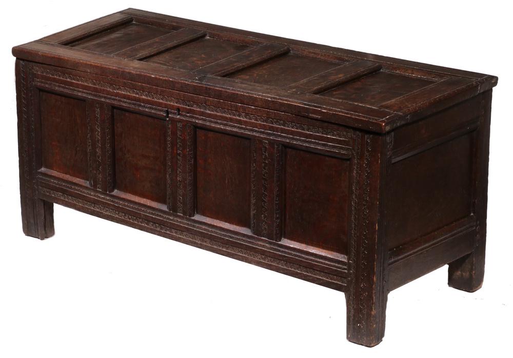 17TH C. ENGLISH OAK COFFER: Early Coffer with four molded panel lid, worn dentil carvings, ribbed frame, retaining the original snipe hinges and lock (no key), matching front and end panels, raised on linen fold stiles, 21 1/2",