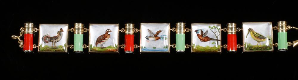 14K GOLD INTAGLIO PANEL BRACELET: Hunting Bracelet in 14K yellow gold, with (5) intaglio panels depicting game birds, separated by green and red enamel shotgun shells. 6 1/2" long, 1/2" wide.