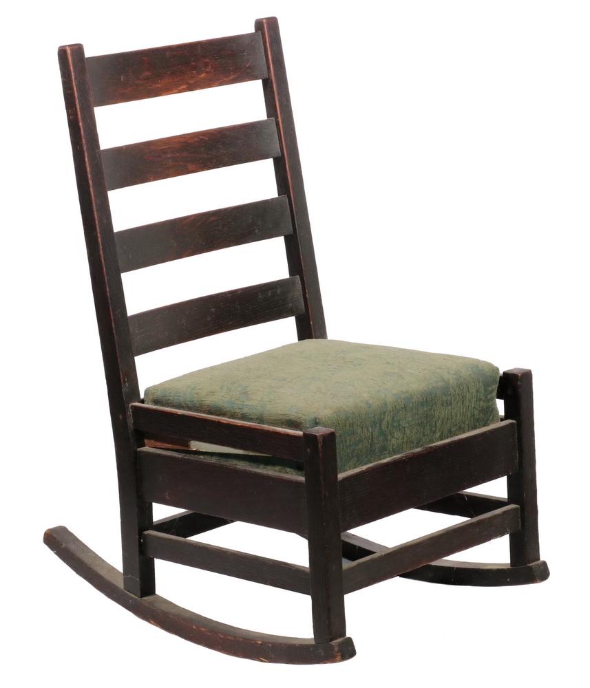 STICKLEY SEWING ROCKER: Rocker No. 303, in fumed quarter sawn oak, having a four concave horizontal slat back, narrow slay side rail and lower stretcher flanking the heavier seat frame that holds a green fabric upholstered d