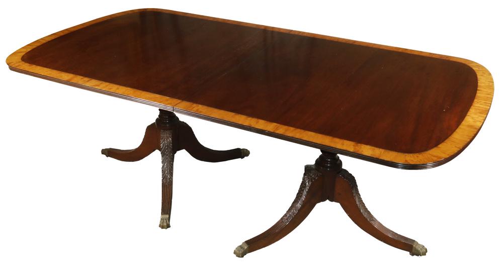 DINING TABLE: Fine Quality 20th c. Duncan Phyfe style Mahogany Dining Table, with satinwood edge banding, set on well carved double pedestals ending in brass paw feet, 29" x 42" x 81", plus (2) 19 1/2" drop-in leav