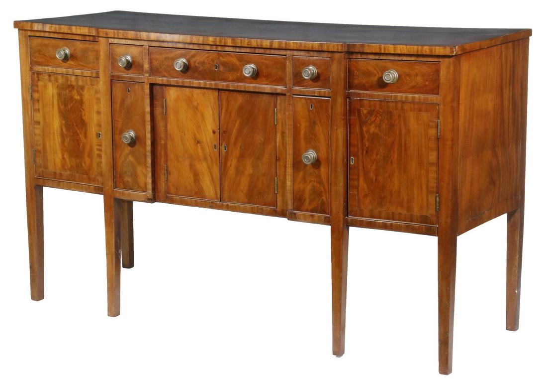HEPPLEWHITE SIDEBOARD: Hepplewhite Mahogany Sideboard, early 19th c., stepped front and overhanging top with crossbanded edge, with flame veneered and cockbeaded drawers and doors, five top drawers, center drawer fronted wi