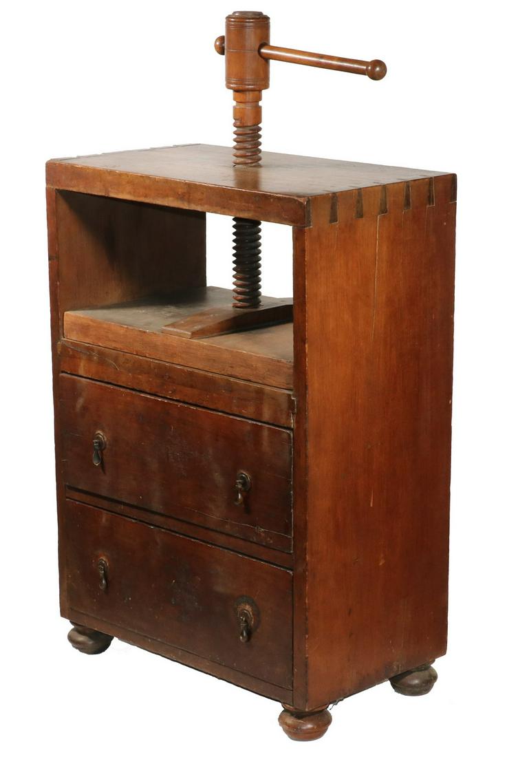 AMERICAN COLONIAL BOOKPRESS ON TWO-DRAWER BASE: Mixed Wood Print Shop Binder's Press, having working components of screw, handle, top, press and bed in cherry, the sides and lower case drawers, in red stained pine, with a sturdy exposed dovetailed 