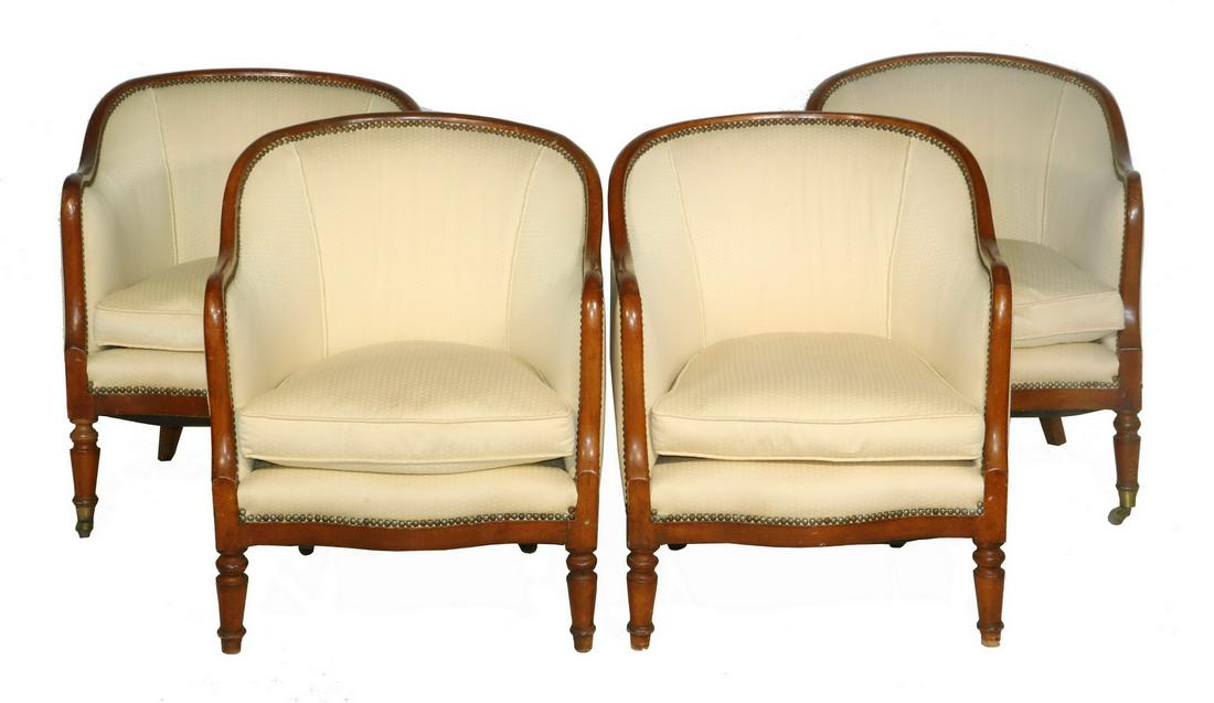 (4) MAHOGANY ARMCHAIRS: Set of (4) Mahogany Framed Bergere Chairs, with shaped front and turned legs, ending on brass cup castors, cream colored upholstery, 29" high, 24" x 28". Surface wear to top of arms. Provenance: From 
