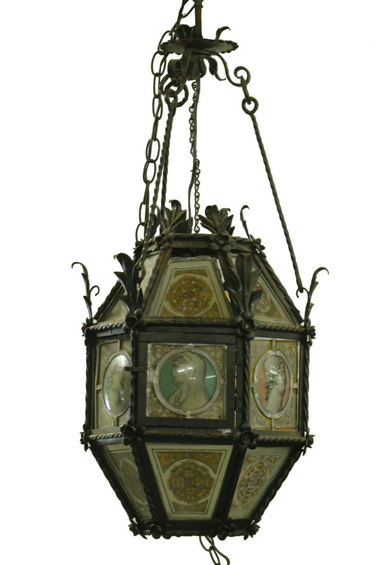 CONTINENTAL IRON AND LEADED GLASS LANTERN: Late 19th c. Gothic Style Wrought Iron Hexagonal Hanging Lantern, probably Italian, c. 1890, electrified, with leaded glass panels with applique decoration, center row of panels with domed inserts con