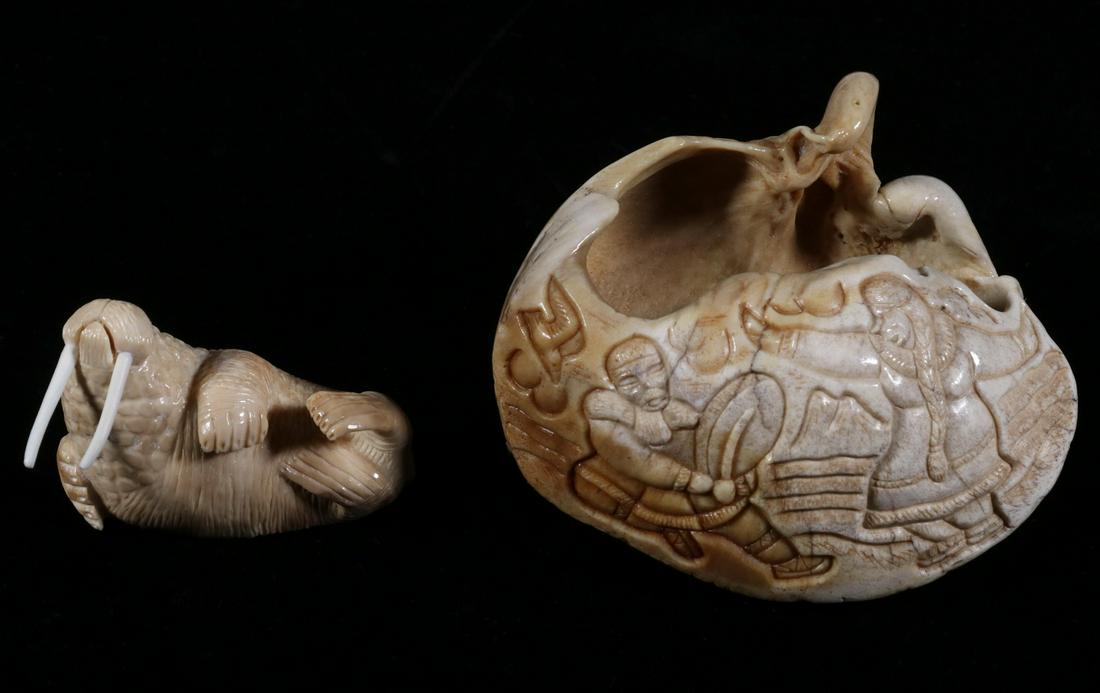 (2) INUIT BONE CARVINGS: Carved Whale Cochlear Earbone, signed "J. Lee", depicting an Inuit couple, the man playing a drum while the woman dances, 4 1/4" long; PLUS a Whalebone Carving of a Walrus, signed "Julian Seppilu, Box