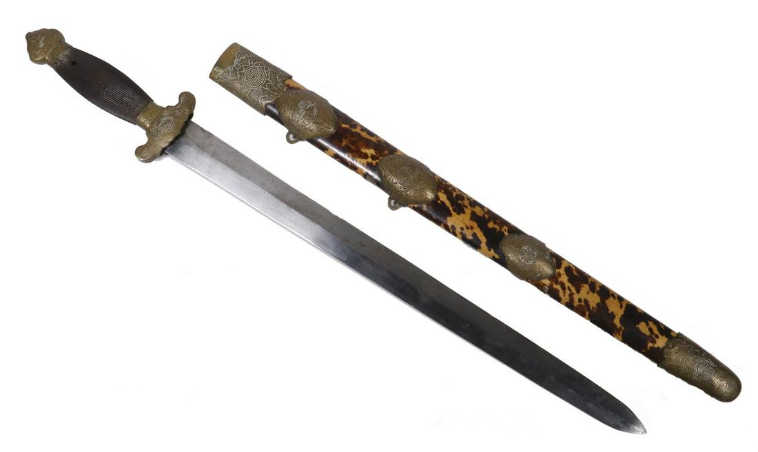 CHINESE DOUBLE-EDGE SHORT SWORD WITH TORTOISESHELL: 19th c. Parade Sword with simple blade, wooden grip, embossed brass fittings, tortoiseshell sheath, 26" long overall. Some loss to tortoiseshell.