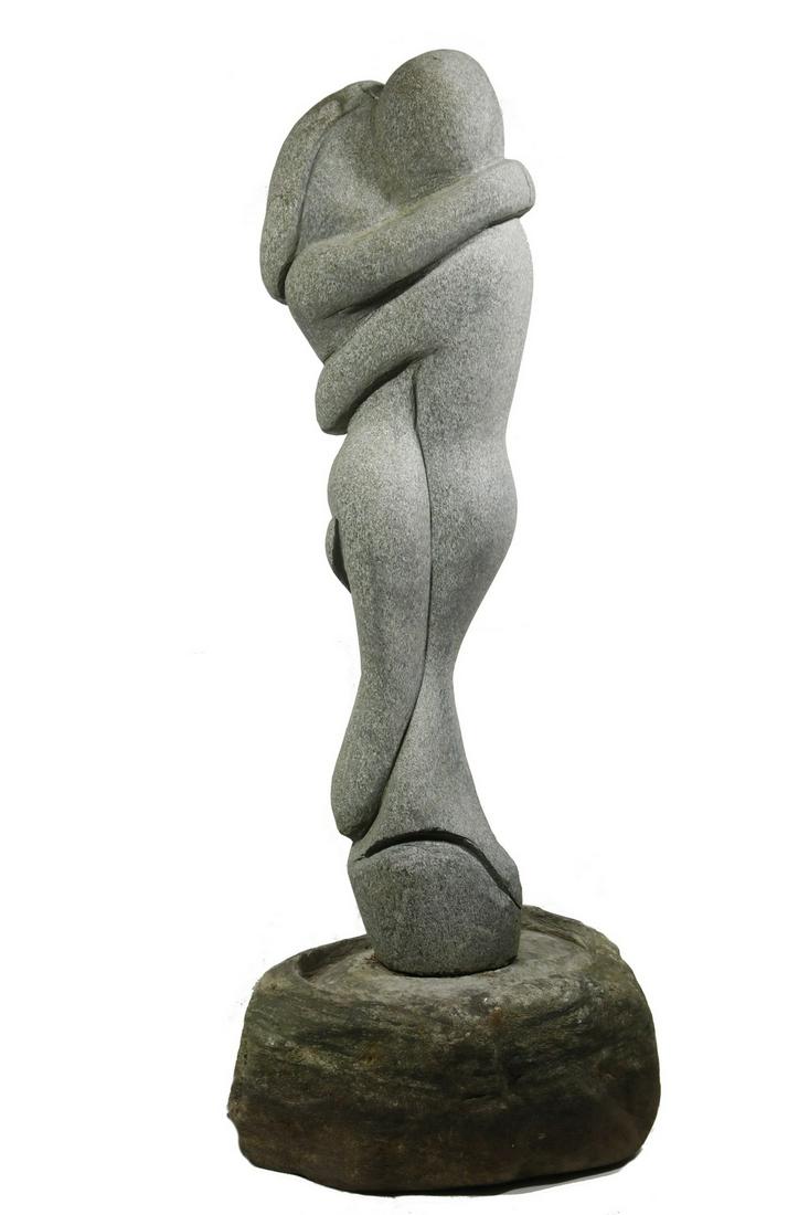 ROBERT VAN DER STEENHOVEN (CONTEMPORARY PEAKS ISLAND,: Embracing Mermaid and Merman, a garden sculpture in carved green granite, two part, set into a separate round plinth, unsigned, 37" tall figure, 8" x 16" diam. plinth. Good condition.