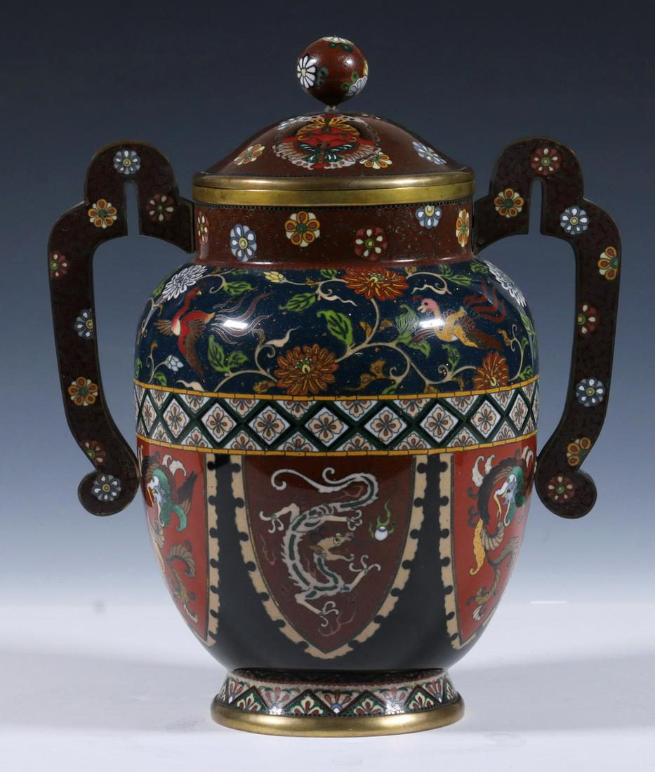 JAPANESE CLOISONNE TWO-HANDLED JAR: Japanese Meiji Period Double Handled Lidded Jar, enamel on brass with floral decorated lid, handle and top rim, shoulder with phoenix bird and floral motifs on a deep blue goldstone ground, above alte