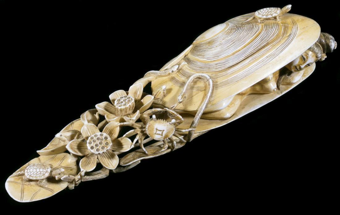 JAPANESE CABINET FIGURE, NUDE IN CLAMSHELL: Beautifully Reticulated Okimono of a Nude Woman Laying Inside a Clamshell, which is adorned with and trailing turtles, snakes, a crab and a frog, among lily pads and blossoms, 8 3/4" long. Shrinkage c