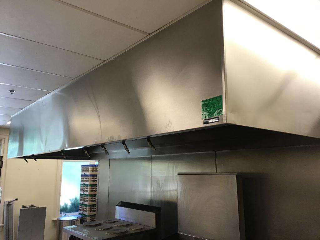 AVTEC FIRE SUPPRESSION SYSTEM: AVTEC stainless steel system includes hood, nozzles, lighting, filters, and floor to ceiling stainless steel backsplash, 60" deep x 14'6" long.