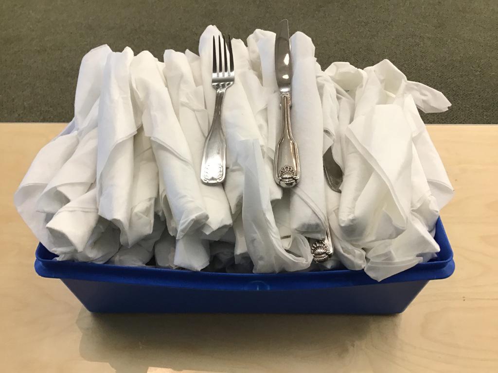 FLATWARE: Lot of shell pattern knife and fork sets, rolled in napkins