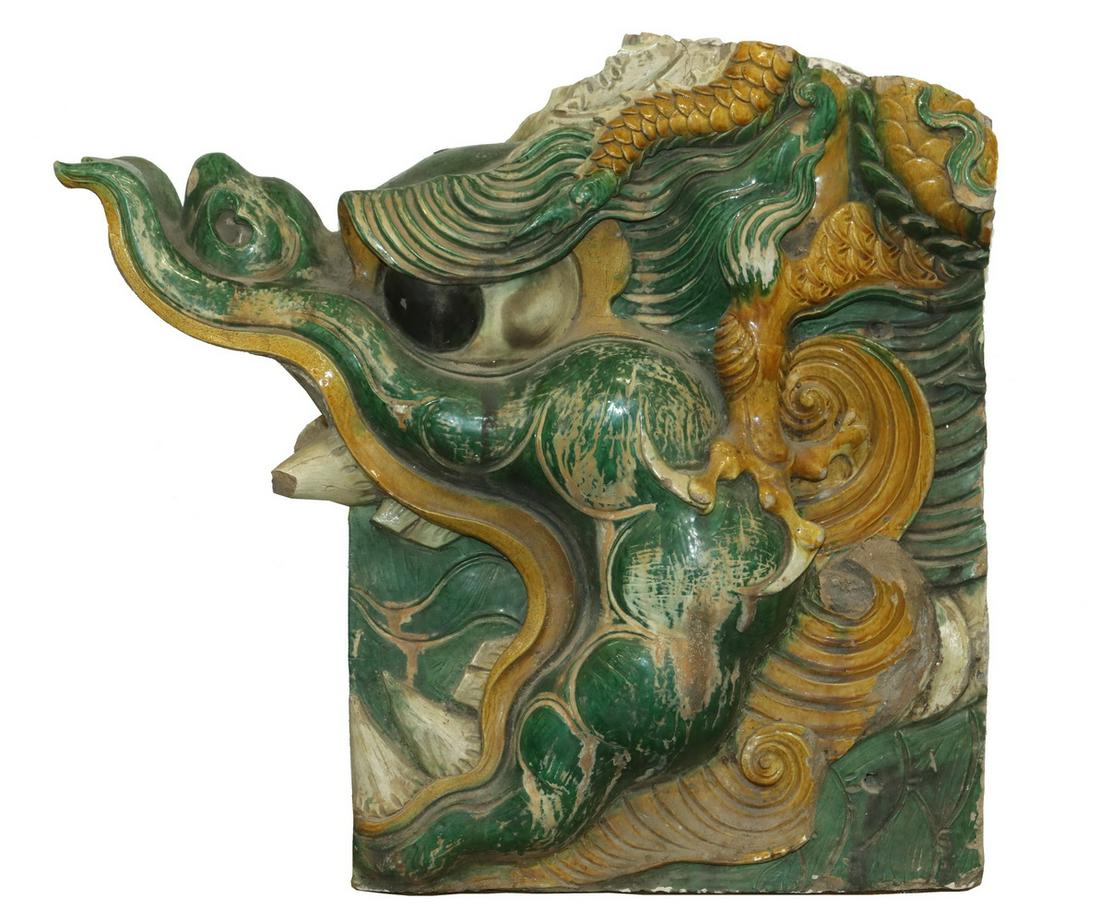 SINGLE LARGE MING GLAZED DRAGON FORM ROOF TILE: Chinese Sancai Glazed Earthenware Roof Tile, bracket, in the form of a dragon head with open mouth, lacking the lower jaw, which was cast separately, roughly 24" x 25" x 11". Some damage, loss to toot