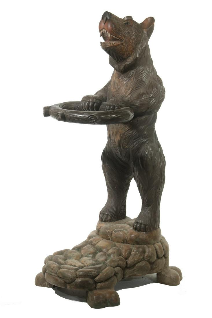 BLACK FOREST CARVED BEAR UMBRELLA STAND: Carved and Painted Wooden Umbrella or Cane Stand, Swiss or German, in the form of a standing bear, with glass eyes, 39" high, 14" x 21". Small shrinkage cracks, small ear chip. Provenance: From Privat