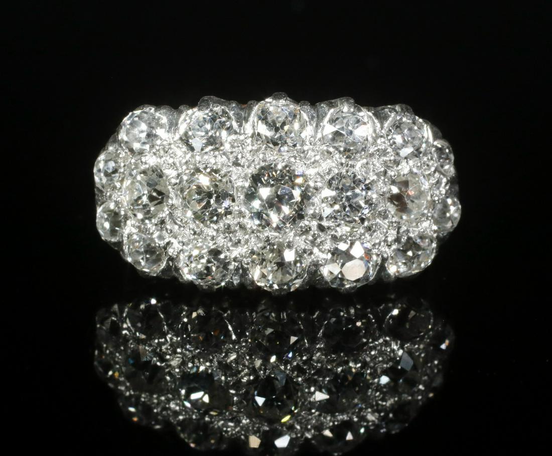 DIAMOND RING: Handmade Victorian Diamond Cluster Form Ring, in18K and platinum, set with (3) rows of old mine cut diamonds across the top from east to west. The (19) diamonds are graduated in size from approx. 0.20