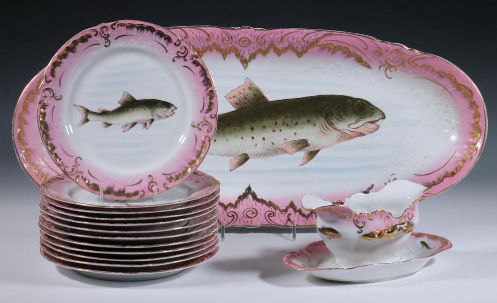 (14 PCS) VICTORIA CARLSBAD PORCELAIN FISH SET: Circa 1900, (14) Piece Austrian Porcelain Fish Service by Victoria Carlsbad, each piece hand painted with different fish, pink edge and gilded rims. Includes: Large oval platter, 24 1/4" x 10 1/2"; Sa