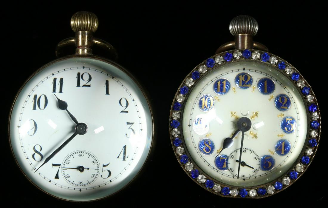 (2) PAPERWEIGHT STEM WIND DESK CLOCKS: The first, with French works, in brass with bejeweled rim having cobalt & clear faux gems, enameled dial with gilt numbers on blue, gilt fleur-de-lis and silver crescent moons, 3 1/8" diam., 3 3/4" to
