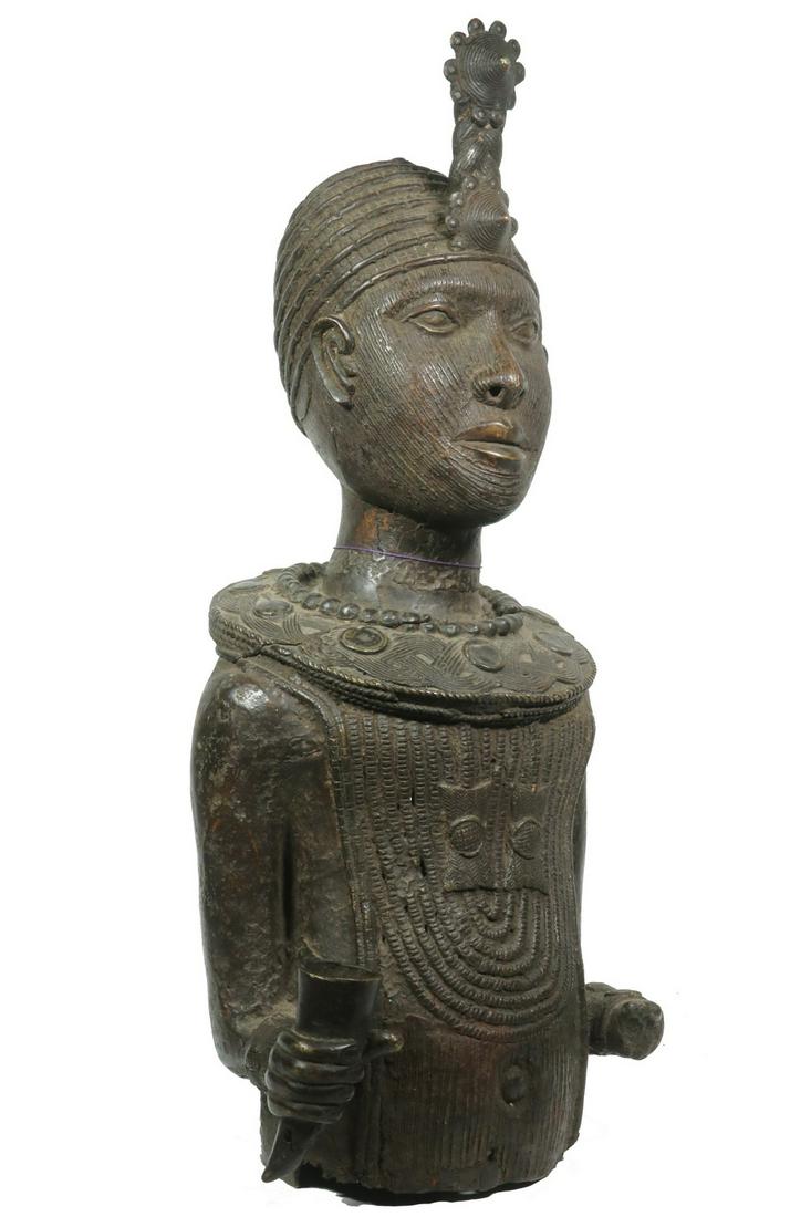 LIFE-SIZED BENIN IFE BRONZE BUST PORTRAIT OF A QUEEN: Classic Portrait of an Ife Queen, with basket hat having pectoral front, scarification to face, large collar and necklace, holding a drinking horn in the right hand, her left hand gone, 26 1/2" x 11 1