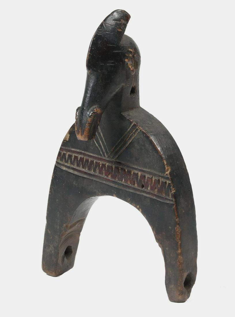 AFRICAN CARVED WOOD TOOL: Baule Heddle Pulley, Ivory Coast, with anthropomorphic animal head, incised decoration, 6 3/4". Lacking wheel. Provenance: From the Estate of Thomas Cavanaugh of Maine and Florida.