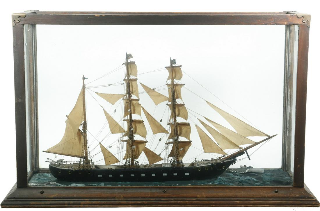 EARLY SHIP MODEL: 19th c. Cased Model of Barque "White Wings", fully rigged with sails unfurled, flying the American flag, set in a painted plaster sea, in a wooden case with glass top, front, back and side panels, 17