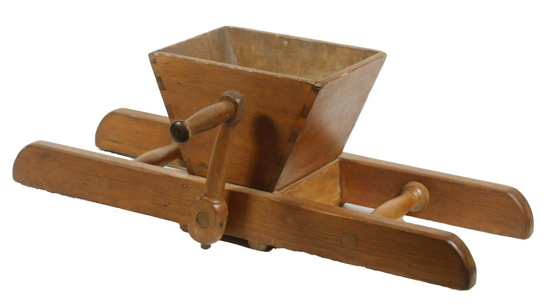 SHAKER CORN MILLING TOOL: Shaker Made Wooden Crank Operated Corn Milling Machine, with dovetailed hopper, turned and pegged wooden crank, 10" high, 29 1/2" x 16". Surface wear, shrinkage crack to hopper interior. Provenance: P